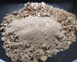 A picture of step 3 of Wheat flour seeds and nuts Ladoo with leftover ghee residue.