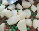 A picture of step 2 of Aloo matar gajar mix veggies.
