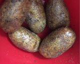 A picture of step 1 of Air Fryer Baked Potato Baked Garlic Parsley Potatoes.