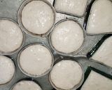 A picture of step 2 of Alkubus with onion sauce.