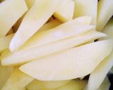 A picture of step 2 of Fried potato wedges.