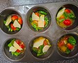 A picture of step 3 of Egg Cups With Tomato, Swiss, and Spinach.