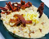 Foto del passaggio 5 della ricetta Risotto ai Peperoni Cruschi con Capocollo e Caciocavallo Podolic
