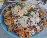 A picture of step 2 of Nachos with salsa.