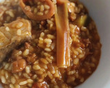 Foto del paso 11 de la receta: Arroz meloso de bacalao, calamar, ajos tiernos y alcachofas