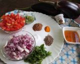 A picture of step 1 of Baingan bharta (smoked eggplant with spices).