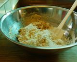 A picture of step 4 of COCONUT MUFFINS with blue berries and chocolate chips.