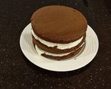 A picture of step 18 of Mocha Layer Cake with Whipped Mascarpone Cream and a Coffee Glaze Drizzle.