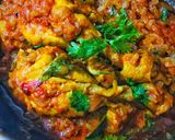 A picture of step 12 of Chicken Tangdi Masala.