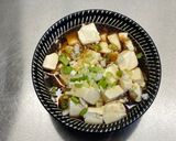 A picture of step 8 of Steamed tofu with sweet soy dressing sauce and spring onions.