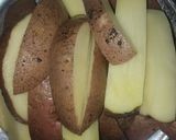 A picture of step 1 of Garlic buttery potato wedges.