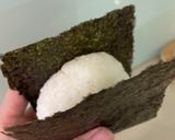 A picture of step 3 of Onigiri with salmon flakes.