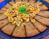 A picture of step 12 of Kibbee Busta (Baked Kibbee with onion and pine nuts).