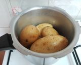 A picture of step 1 of Maggi stuffed jacket potatoes.