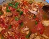 A picture of step 3 of Spanish style tomato and chicken baked rice.
