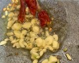 A picture of step 1 of Palak with brinjal and badi.
