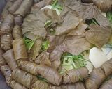 A picture of step 5 of Dolmadakia Yalantzi (Stuffed Grape Leaves).