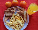 A picture of step 4 of Cheese and Tomato Grilled Sandwich with French Fries.