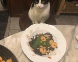 A picture of step 4 of Squid Ink Tagliolini with Grilled Shrimp, Mustard Pesto, and Toasted Pine Nuts.