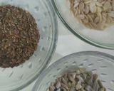 A picture of step 3 of Besan laddoo with sunflower and flax seeds.