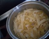 A picture of step 1 of Pad thai with king prawns and lemon slices and tagliatelle rice.
