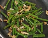 A picture of step 3 of French beans tossed with nuts and feta cheese salad.