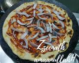 A picture of step 2 of Tawa Veg Pizza with Olives.