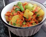 A picture of step 4 of Aloo matar gajar mix veggies.