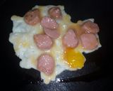 A picture of step 5 of Smokie fried in egg.