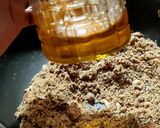 A picture of step 4 of Wheat flour seeds and nuts Ladoo with leftover ghee residue.