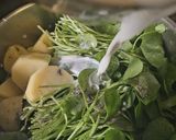 A picture of step 2 of Purslane Soup with Goat Cheese Whipped Cream and Hazelnut Oil.