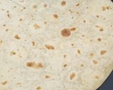 A picture of step 1 of Speck, brie and red onion piadina.