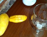 A picture of step 3 of Mango milk shake with chocolate and nuts.