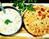 A picture of step 9 of Alu paneer paratha serve with boondi raita.