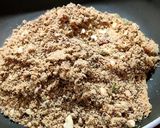 A picture of step 5 of Wheat flour seeds and nuts Ladoo with leftover ghee residue.
