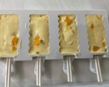A picture of step 4 of Mango and Passion Fruit Shrikhand Popsicles.