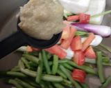 A picture of step 1 of Manchow Soup / Veg soup topped with Crispy fried noodles.