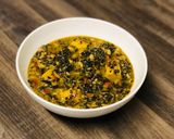 A picture of step 12 of White Bean and Swiss Chard Egusi Soup with seed coated Polenta bites.