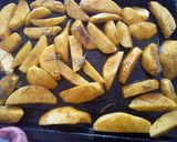 A picture of step 4 of Rosemary baked potato wedges.