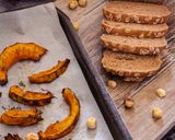 A picture of step 1 of DARK MULTIGRAIN BREAD CROSTINI WITH GOAT RICOTTA, ROASTED SQUASH, AND HONEY.