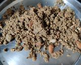 A picture of step 5 of Wheat flour seeds and nuts Ladoo with leftover ghee residue.