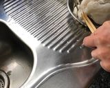 A picture of step 3 of Congee, with dried scallops.