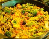 A picture of step 5 of Multi colored pilaf with broccoli, red and orange bell peppers, and carrots.