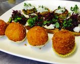 A picture of step 4 of Arancini ai formaggi - deep-fried, risotto balls with melting cheese middle.