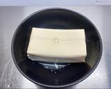 A picture of step 2 of Steamed tofu with sweet soy dressing sauce and spring onions.