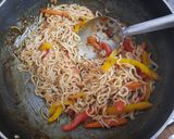 A picture of step 2 of Schezwan noodles in noodles basket with kiwi banana smoothie.