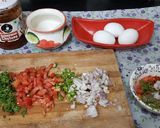 A picture of step 2 of Schezwan chutney brown Bread 🍞 tomato 🍅 onion omellete.