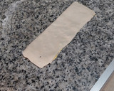 Foto del paso 3 de la receta: Triángulitos de hojaldre rellenos de crema y pepitas de chocolate
