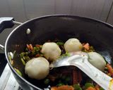 A picture of step 12 of Stuffed Riceballs tossed in mix vegetables.