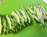A picture of step 3 of Enoki mushrooms and cucumber with umeboshi flavored ponzu dressing.